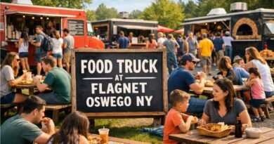 Food truck at Flagnet Oswego NY with multiple food trucks, picnic tables, and locals enjoying outdoor street food in a community setting.